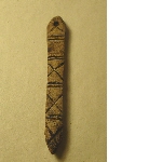 Facsimile of a bone awl decorated with engraved lines